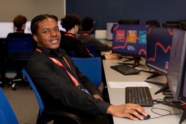 Two students siting and smiling in a library