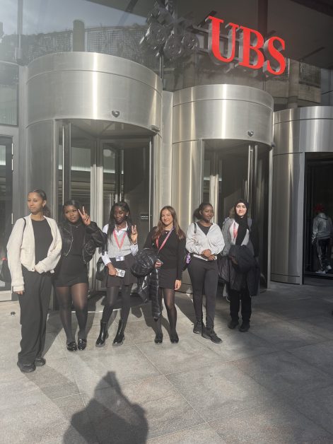 a group SBUSixth Students standing outside of an ubs building